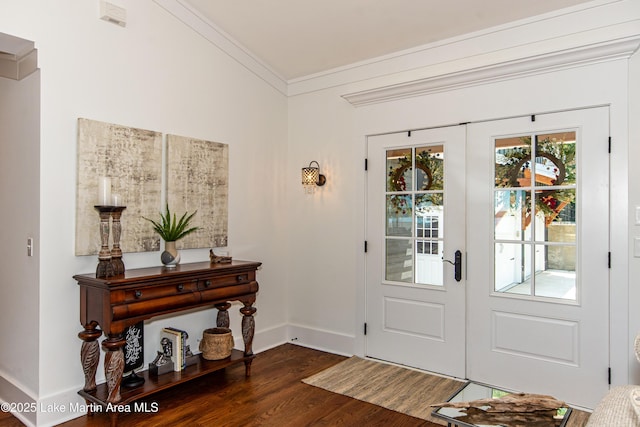 foyer featuring french doors, dark hardwood / wood-style floors, and crown molding