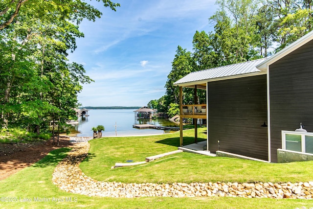 view of yard featuring a water view and a dock