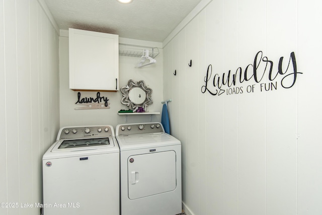 washroom with cabinets, separate washer and dryer, and a textured ceiling