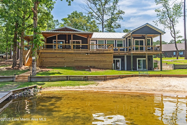 rear view of house featuring a water view