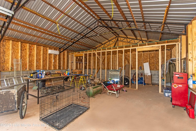 misc room featuring lofted ceiling and concrete floors