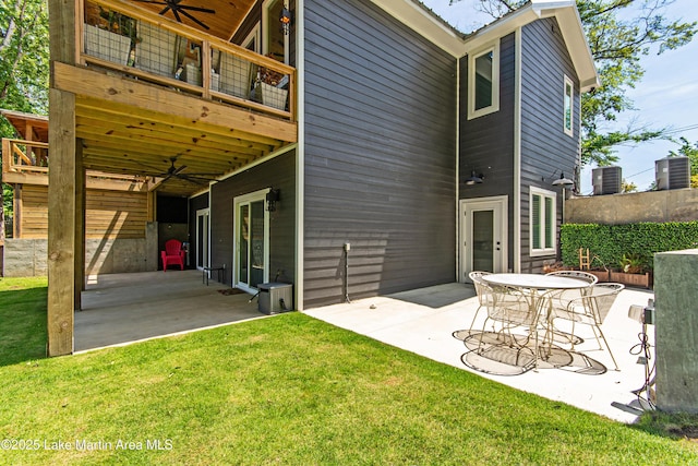 rear view of house with a patio area, a balcony, ceiling fan, and a lawn