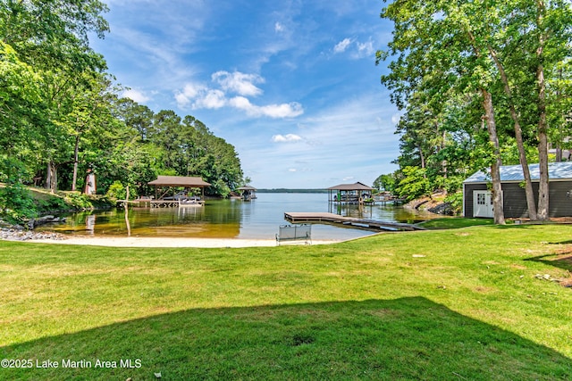 dock area featuring a water view and a lawn