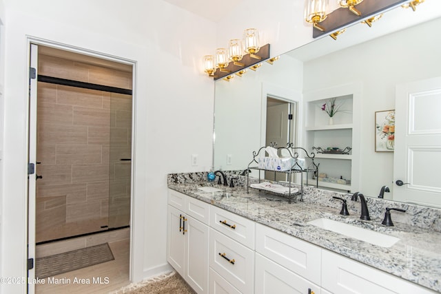 bathroom with vanity, built in shelves, and tiled shower