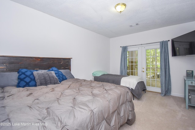 93 Restful Cv, Dadeville, AL 36853 - bedroom with carpet floors, french doors, access to exterior, and a textured ceiling