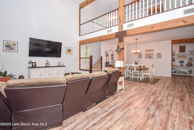 93 Restful Cv, Dadeville, AL 36853 - living area featuring a towering ceiling, wood finished floors, stairway, and a chandelier
