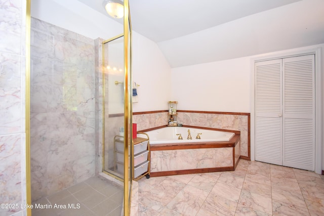 93 Restful Cv, Dadeville, AL 36853 - bathroom with marble look tile flooring, a stall shower, lofted ceiling, a bath, and a closet