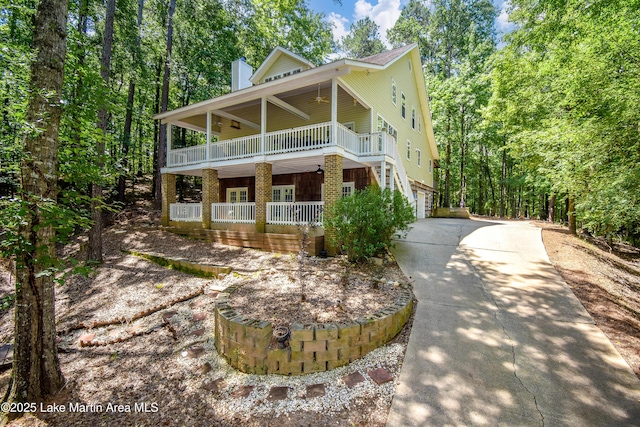 93 Restful Cv, Dadeville, AL 36853 - view of front of home featuring covered porch, a ceiling fan, concrete driveway, a chimney, and an attached garage