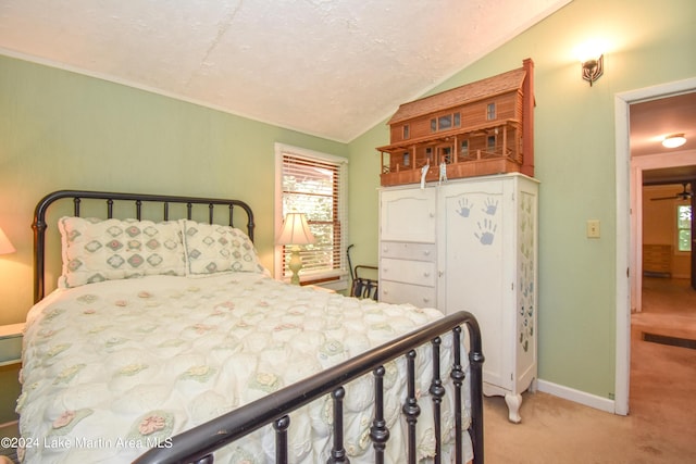 carpeted bedroom with a textured ceiling and vaulted ceiling