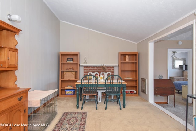 dining space featuring light colored carpet, ornamental molding, and vaulted ceiling