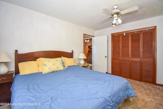 carpeted bedroom with ceiling fan and a closet