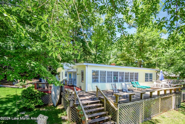 rear view of property featuring a deck