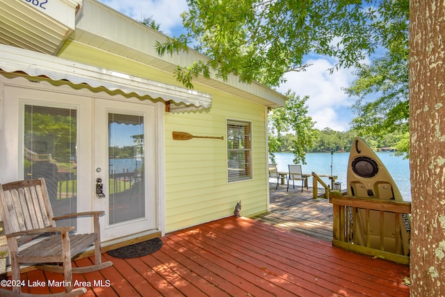 wooden terrace featuring a water view