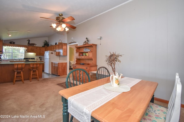 dining room featuring ceiling fan, light colored carpet, and lofted ceiling