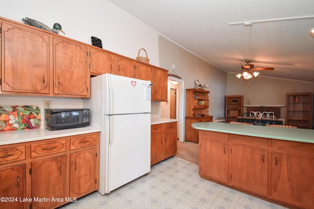 kitchen with white refrigerator, vaulted ceiling, and ceiling fan