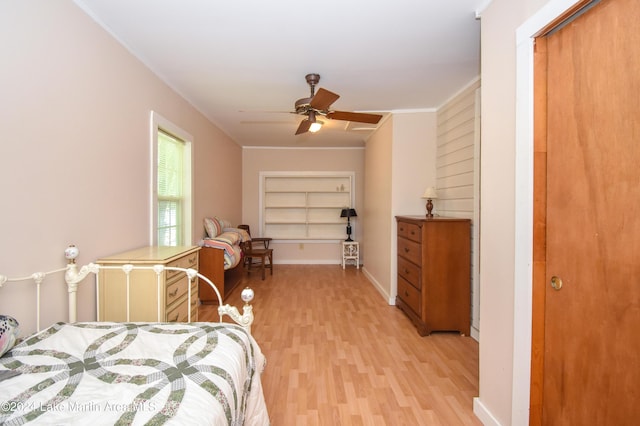 bedroom with ceiling fan, a closet, ornamental molding, and light wood-type flooring