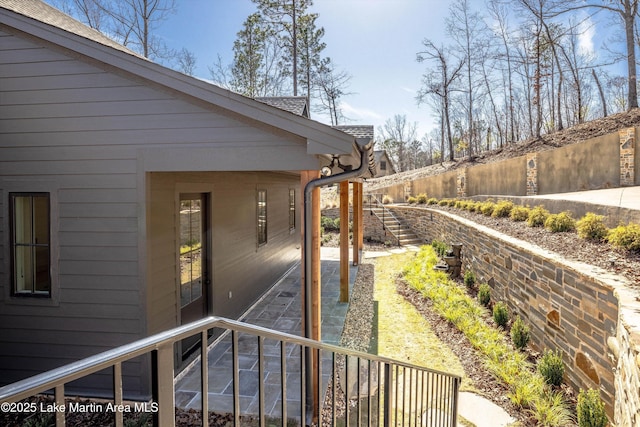 view of side of home featuring fence