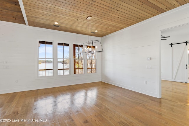 unfurnished dining area featuring a barn door, wood finished floors, and wood ceiling