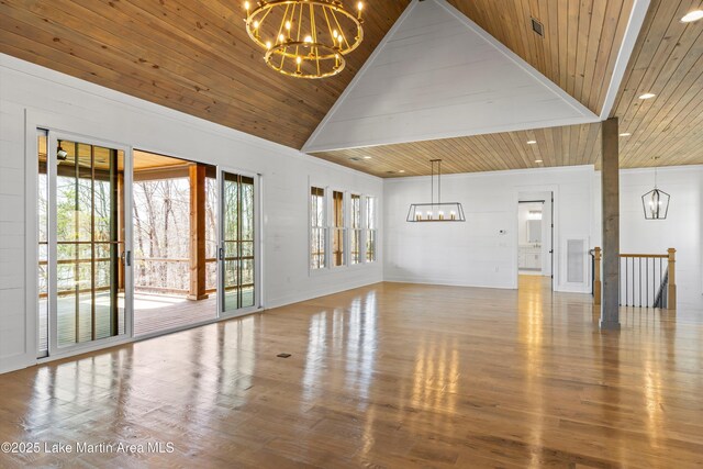 unfurnished living room featuring a notable chandelier, wood ceiling, wood finished floors, and high vaulted ceiling