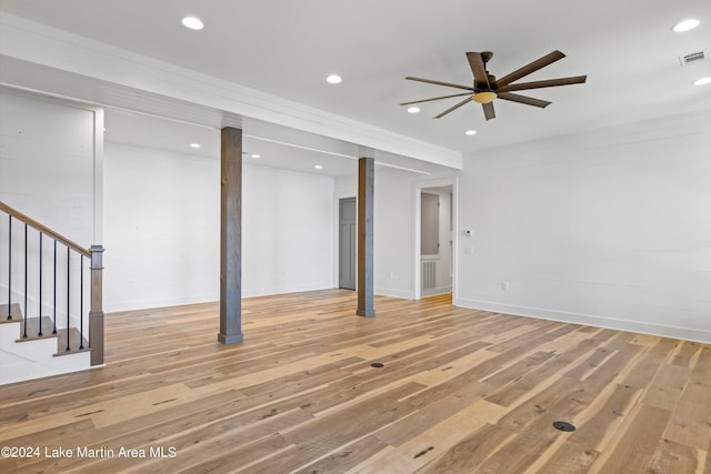 basement featuring hardwood / wood-style flooring and ceiling fan