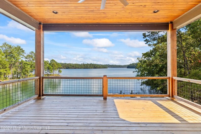 deck featuring ceiling fan and a water view