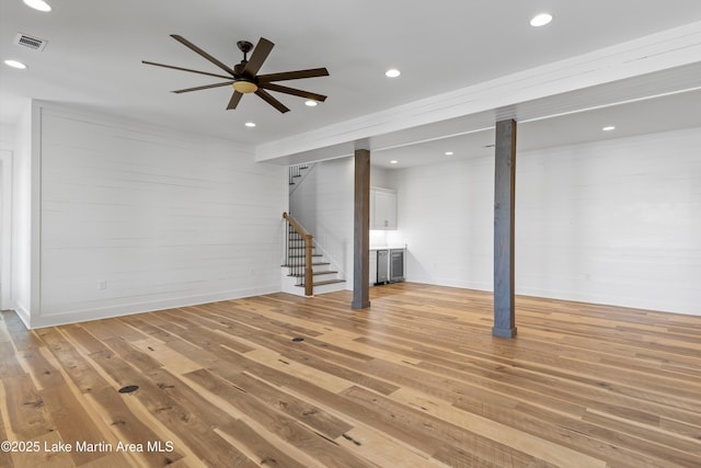 basement with stairway, visible vents, recessed lighting, ceiling fan, and light wood-type flooring