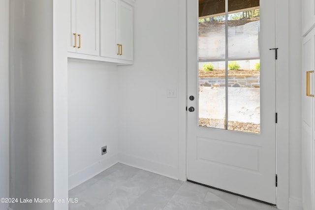 laundry room with cabinets, a wealth of natural light, and electric dryer hookup