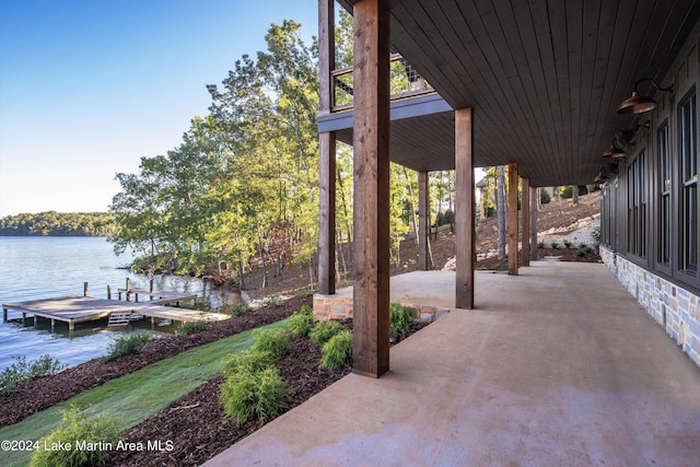 view of patio / terrace featuring a boat dock and a water view