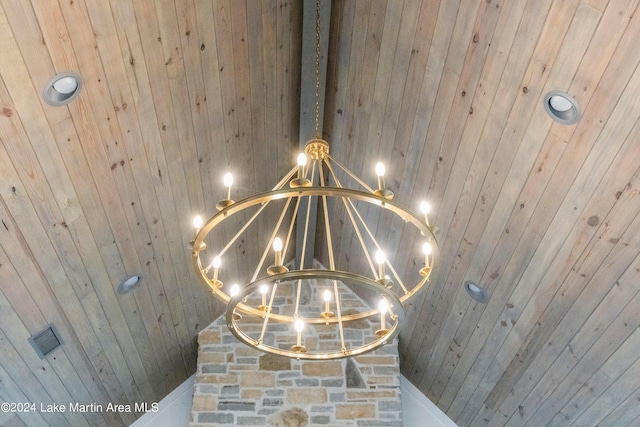 interior details featuring a notable chandelier and wood walls