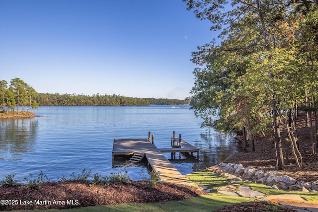 dock area with a view of trees and a water view