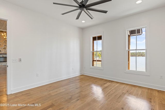 spare room with recessed lighting, baseboards, light wood-style flooring, and ceiling fan