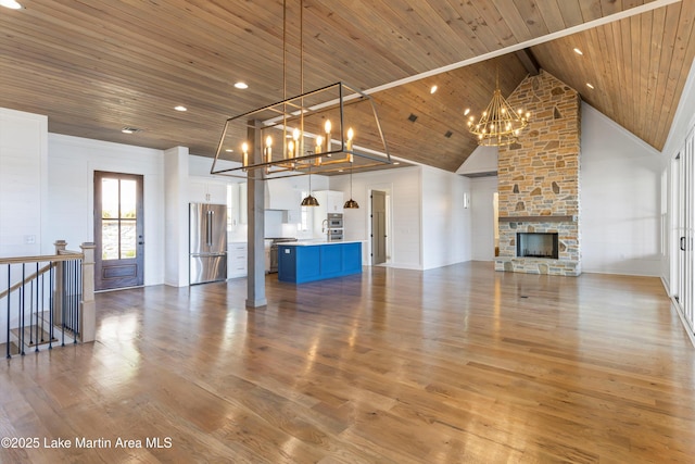 unfurnished living room featuring wood finished floors, high vaulted ceiling, a chandelier, and wooden ceiling