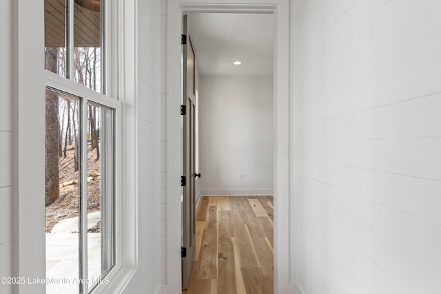 hallway with recessed lighting, baseboards, and light wood-style flooring