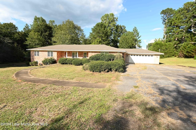 single story home featuring a front yard and a garage