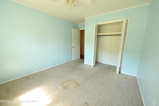 unfurnished bedroom with ceiling fan, a closet, and light colored carpet