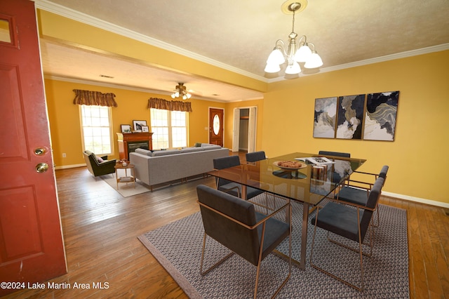 dining room with dark hardwood / wood-style flooring, ceiling fan with notable chandelier, and ornamental molding