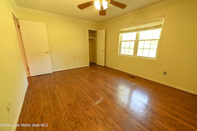 unfurnished bedroom featuring crown molding, a closet, ceiling fan, and wood-type flooring