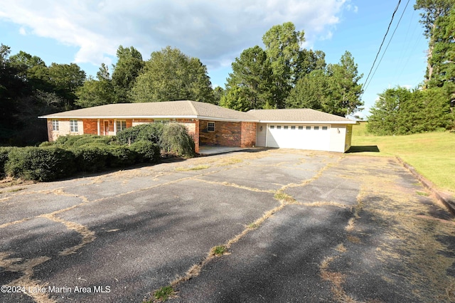 ranch-style house with a garage and a front yard