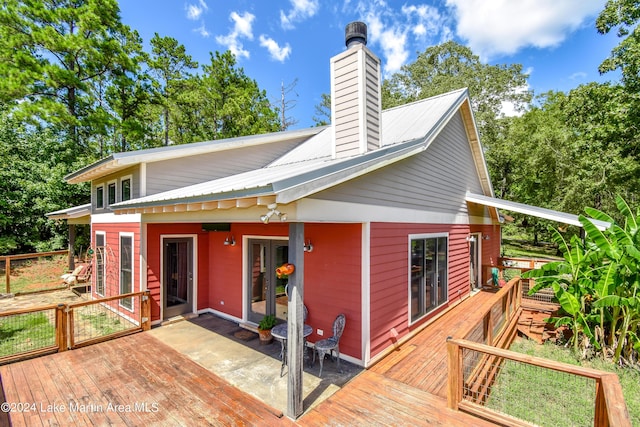 back of house with french doors and a wooden deck