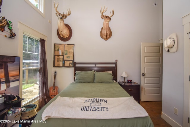 bedroom with dark hardwood / wood-style flooring