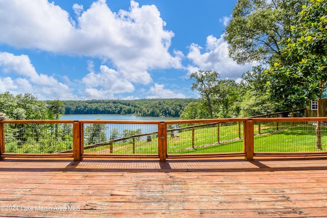 deck with a yard and a water view