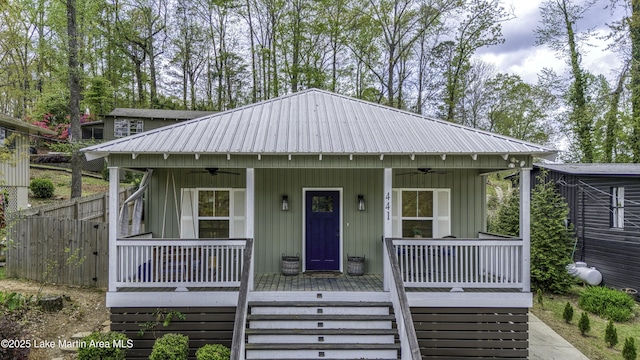 441 Cove Dr, Eclectic, AL 36024 - view of front facade with metal roof, ceiling fan, stairway, and covered porch