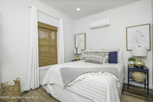 441 Cove Dr, Eclectic, AL 36024 - bedroom featuring a wall mounted AC, wood finished floors, baseboards, and recessed lighting