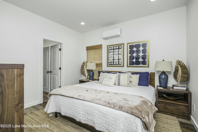 441 Cove Dr, Eclectic, AL 36024 - bedroom featuring recessed lighting, an AC wall unit, baseboards, and wood finished floors
