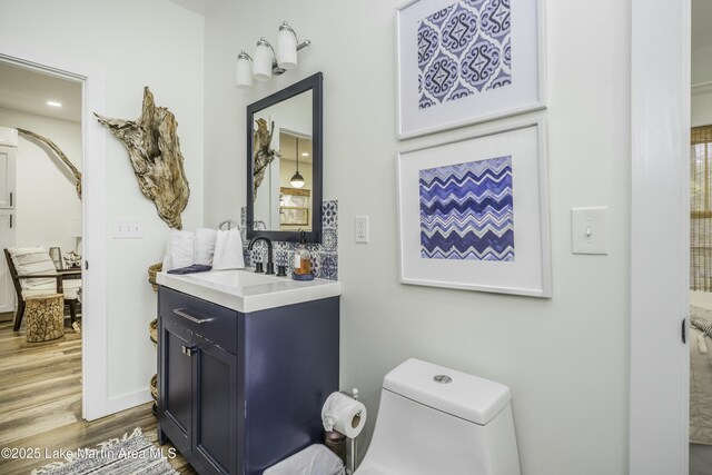 441 Cove Dr, Eclectic, AL 36024 - bathroom featuring toilet, wood finished floors, and vanity