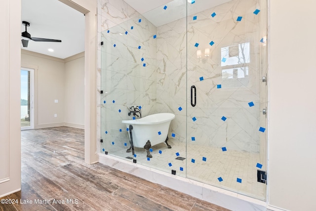 bathroom featuring wood-type flooring, ceiling fan, and shower with separate bathtub