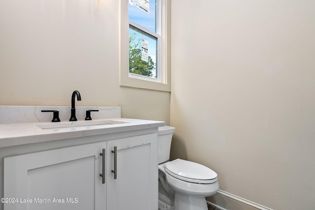 bathroom featuring toilet and vanity