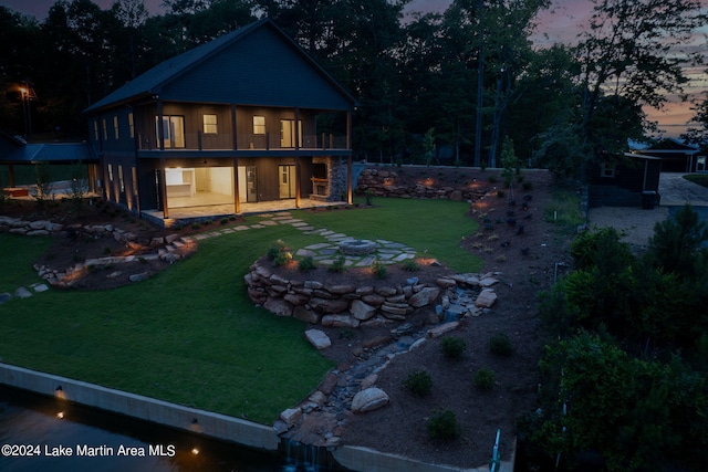 yard at dusk featuring a patio