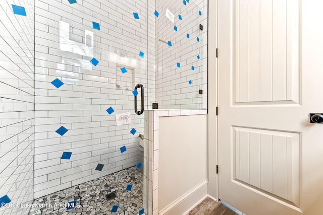 bathroom with tiled shower