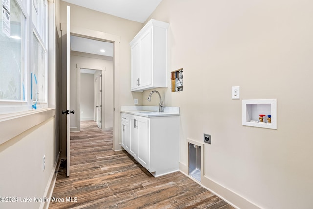 washroom with cabinets, dark hardwood / wood-style flooring, sink, washer hookup, and hookup for an electric dryer